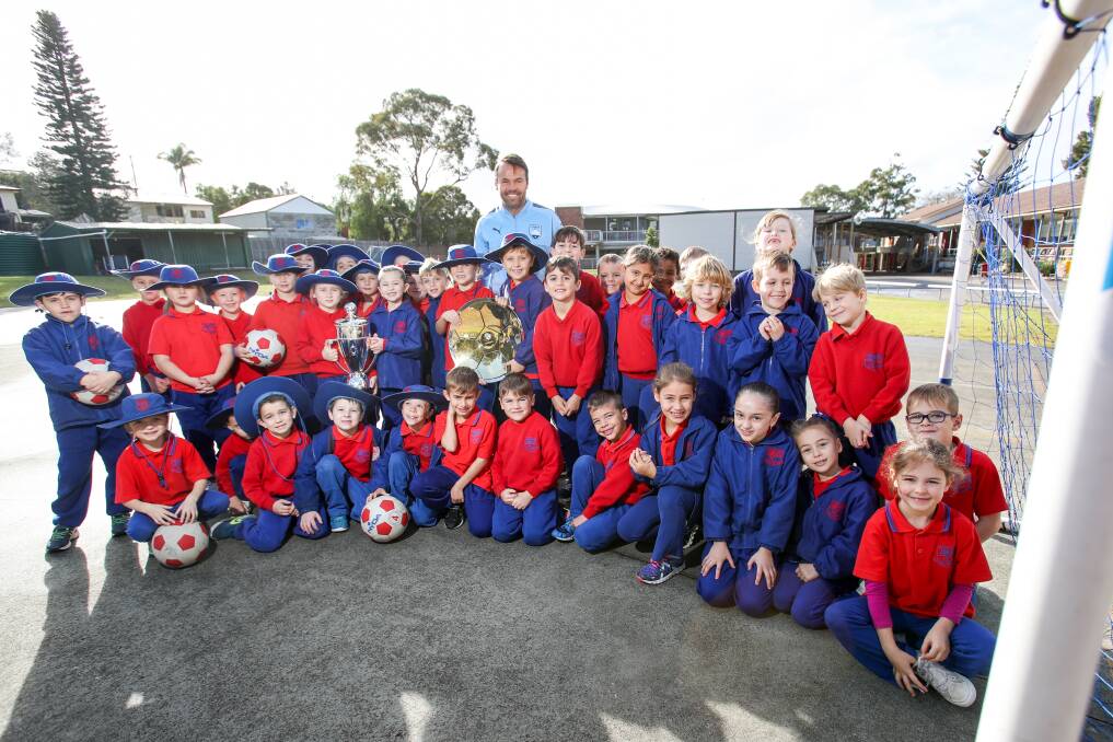 Kicking goals: Sydney FC's Paul Reid with students from St Pius X Catholic Primary School. Picture: Adam McLean. 