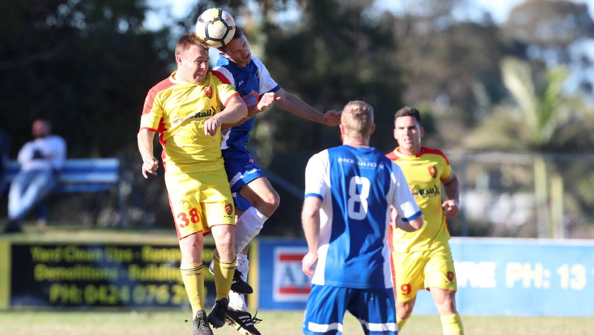 Heads up: Wollongong United's Sam Munro (left) and Tarrawanna's Daniel Goodhew go up for a header. Picture: Sylvia Liber