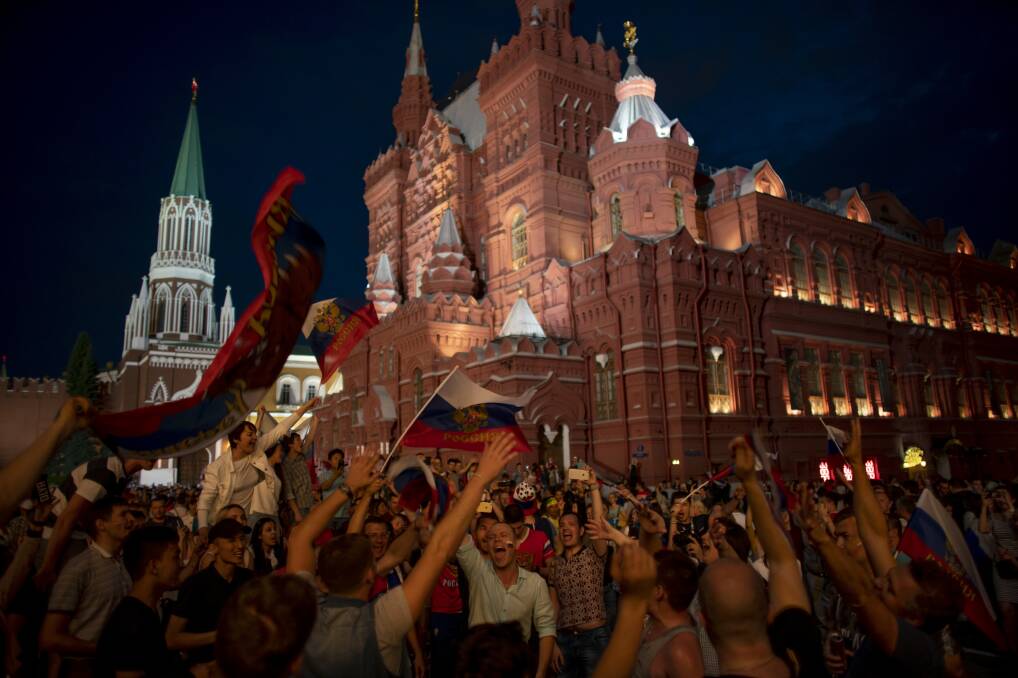 Party time: Fans celebrate in the Red Square after Russia beat Spain in their round of 16 game. Picture: AP Photo/Victor R. Caivano