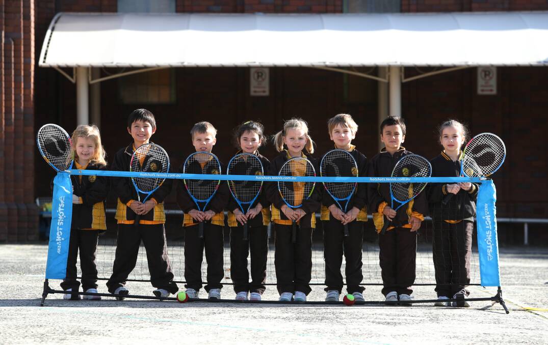 New toys: Students from St Therese Catholic Parish Primary School with their new tennis racquets. Picture: Robert Peet. 
