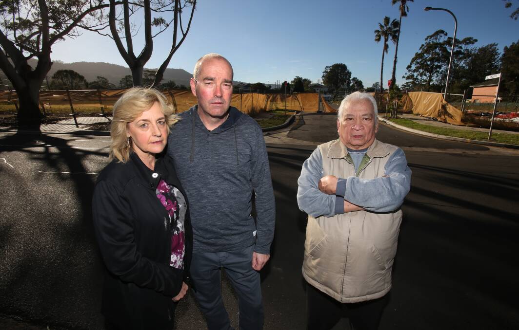 BUYERS LOSE OUT: Ann Hughes, Paul Hughes and Santi Enrile with the Keerong Avenue development behind them. Picture: Robert Peet.