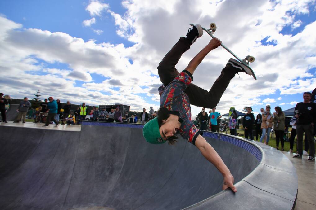 Vans and Totem Skateboarding team member Nixen Osborne doing a hand plant in the bowl at the new Shellharbour Skate Park during the community open day on Saturday. Picture: Adam Mclean.