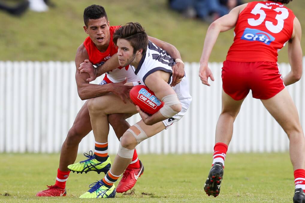 Caught: Shellharbour's James Bell tackles GWS opponent Rhys Pollack during the NEAFL clash. Picture: Adam McLean