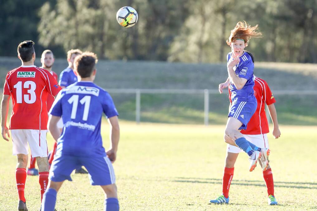 Rising up: Bulli's Marcus Beattie heads the ball in win over Fernhill on Sunday. Picture: Adam McLean