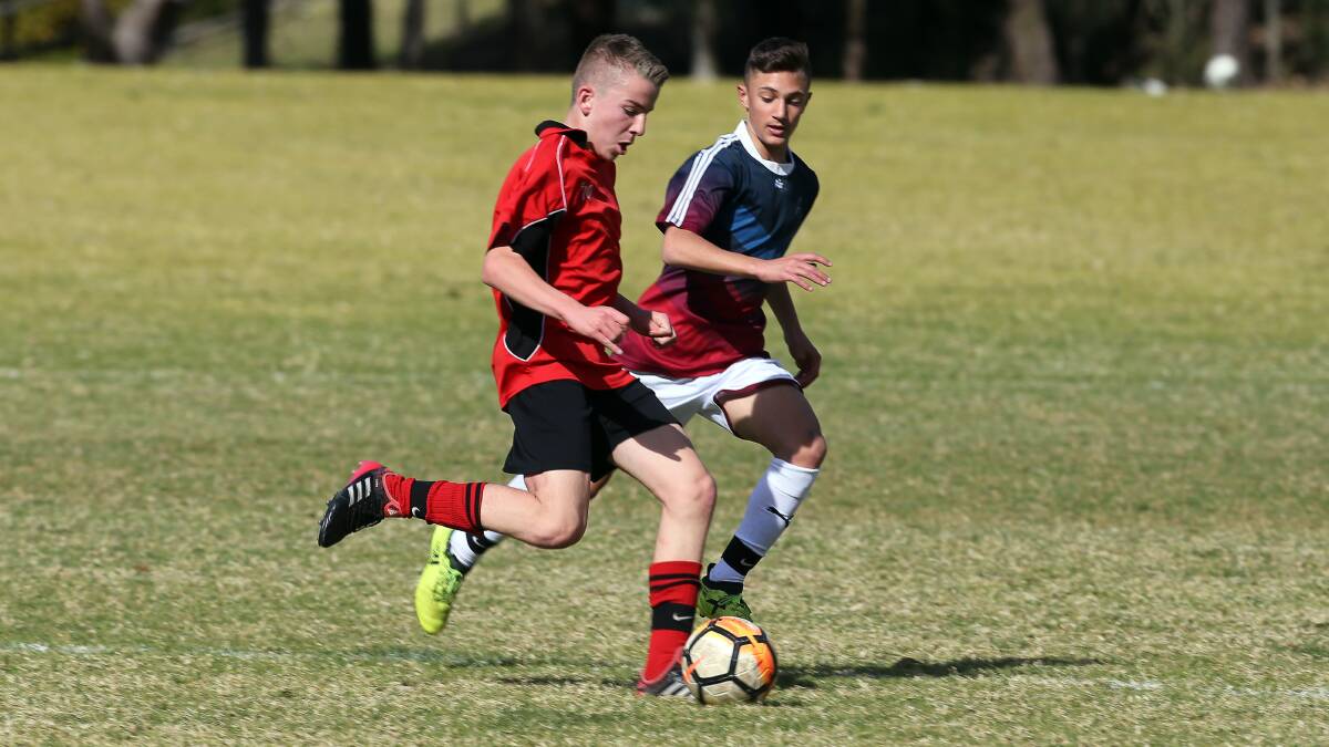 Moving on: Sam Starcic kicking the ball during Edmund Rice College's Bill Turner Cup victory over Holy Spirit College. Picture: Robert Peet. 
