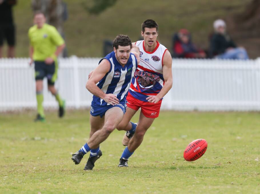 Battle: Figtree's Nick Stacey leads the race to the ball in Saturday's clash with the Bulldogs. Picture: Georgia Matts