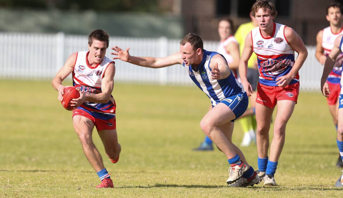 Closing in: Wollongong Bulldogs player Adam Weston is under pressure against Figtree at Keira Oval on Saturday. Picture: Georgia Matts