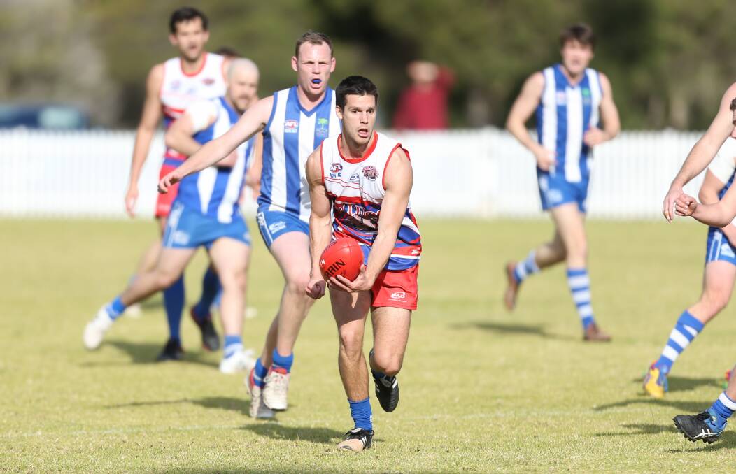 Clear: Wollongong Bulldogs player Matthew Westaway takes on Figtree earlier this season. They meet again in Saturday's minor semi-final. Picture: Georgia Matts