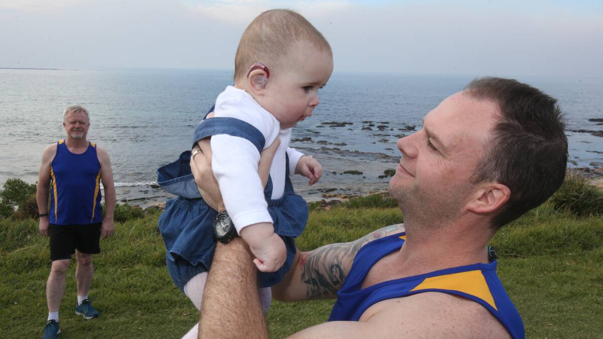 On a mission: Josh Ryan, with his little girl Ava, is in training for this Sunday's City2Surf along with his father Mike. Picture: Robert Peet