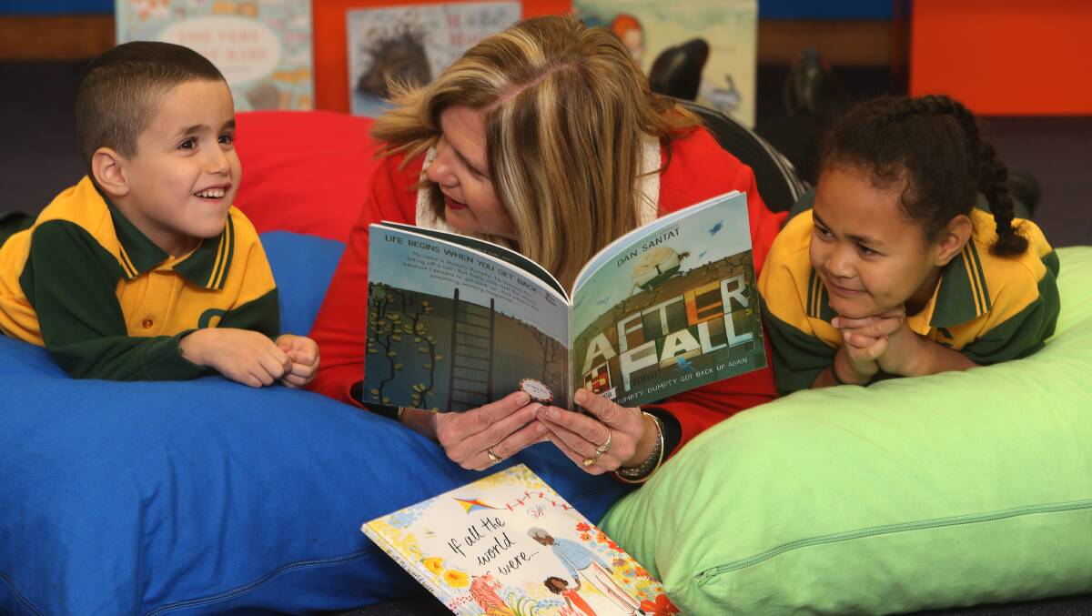 BOOK BOOST: Cringila Public School principal Amanda Giles with students Ali Mawassi and Finau Nisa. The school will get brand new books thanks to the Dymocks' Books for Kids campaign. Picture: Robert Peet