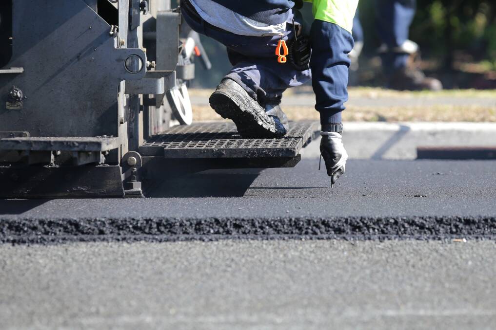 Road works: Warmer weather makes it an ideal time for crews to get out on the road laying new asphalt.  Picture: John Veage