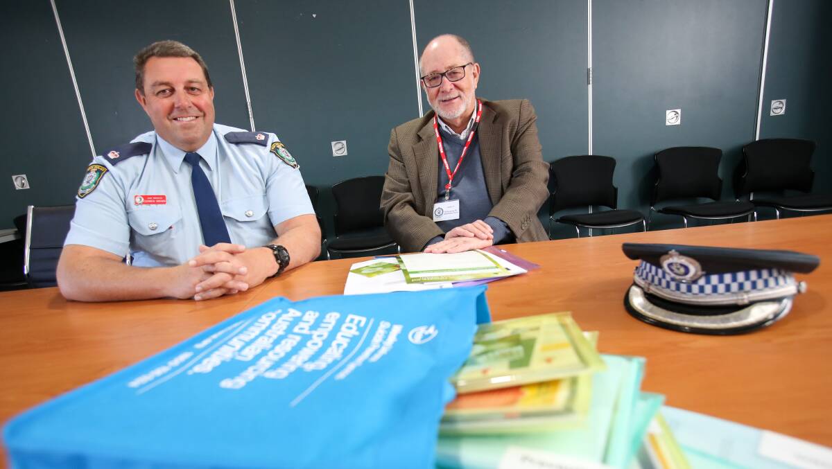 Valuable tool: Wollongong Police Chief Inspector Darren Brown and iSPAN chair Peter Brown with the suicide prevention and bereavement kits. Picture: Adam McLean