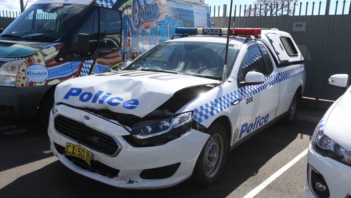 MAJOR DAMAGE: The police car allegedly damaged when two teens driving a stolen car rammed into the vehicle several times on Saturday night in Warrawong. Picture: Robert Peet