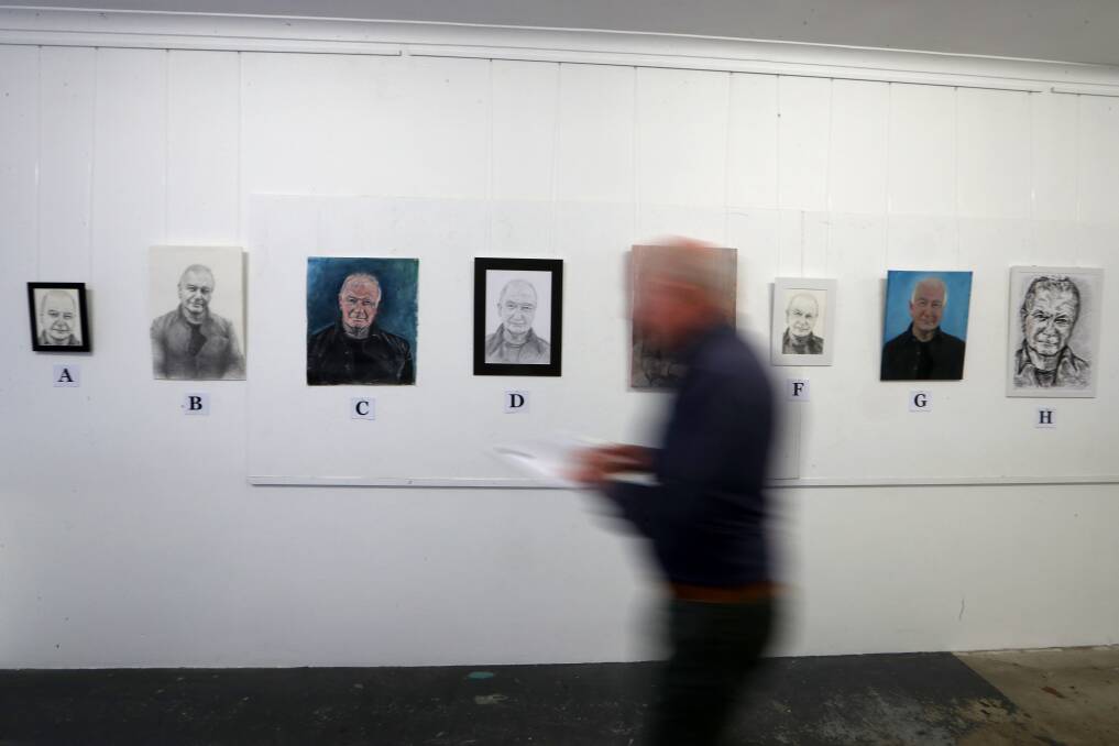 Wollongong Lord Mayor Gordon Bradbery judging the 'likeness' of portraits of himself, for a research project on facial recognition, at RPAA in Port Kembla. Picture: Sylvia Liber