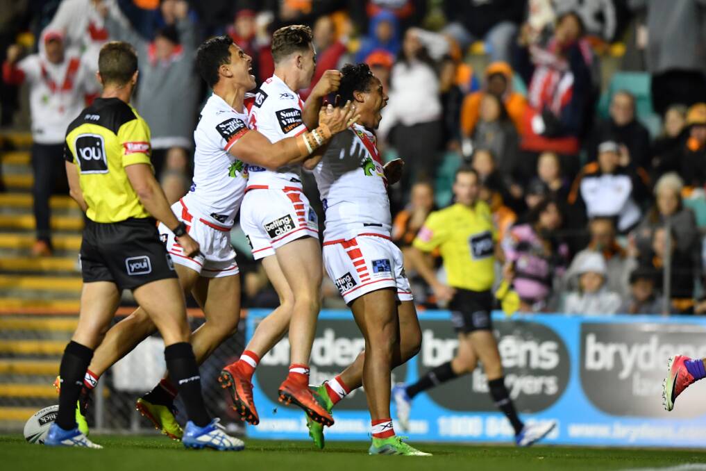 KEY MOMENT: The Dragons celebrate Luciano Leilua's try against the Tigers on Saturday. Picture: AAP
