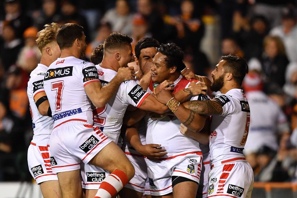 HOW GOOD: Dragons players celebrate Luciano Leilua's try in their win over the Tigers on Saturday. Picture. AAP Image
