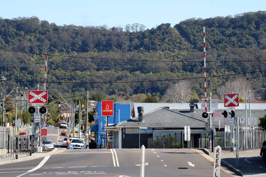 Just wait: When the boomgates are up at Woonona station it's safe to cross - but plenty of people are crossing when they're down too. Picture: Sylvia Liber