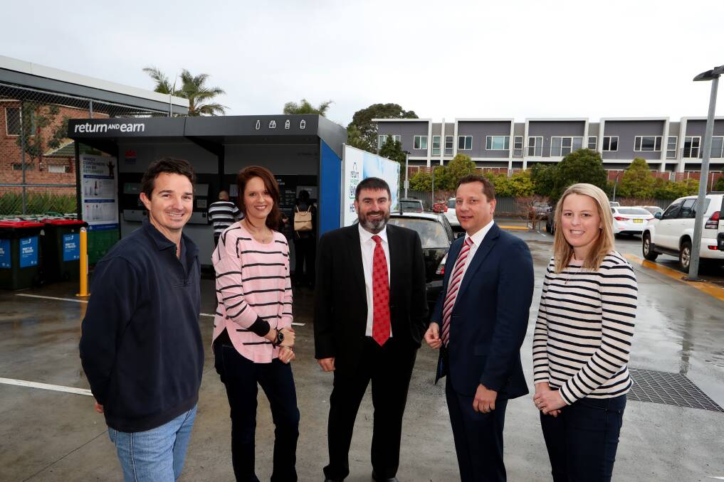 Fairy Meadow business owner Grant Logue, resident Corinne Maccarone, the Fraternity Club's Greg Field, Wollongong MP Paul Scully and resident Laura Clarke with the soon-to-be relocated Return and Earn recycling machine. Picture: Sylvia Liber