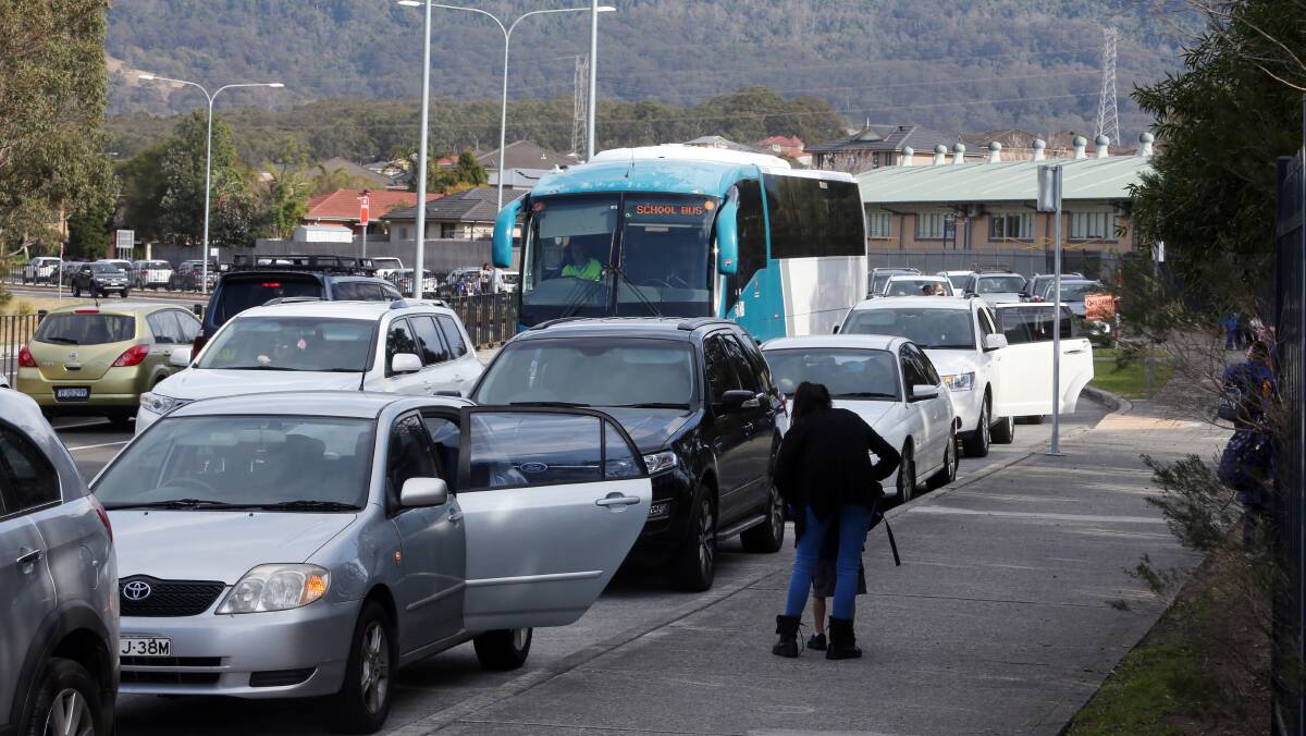 IT'S DANGEROUS: Parents say it gets dangerous for children around the 'gridlocked' Dapto Public School. They hope council will improve infrastructure around the school. Picture: Robert Peet