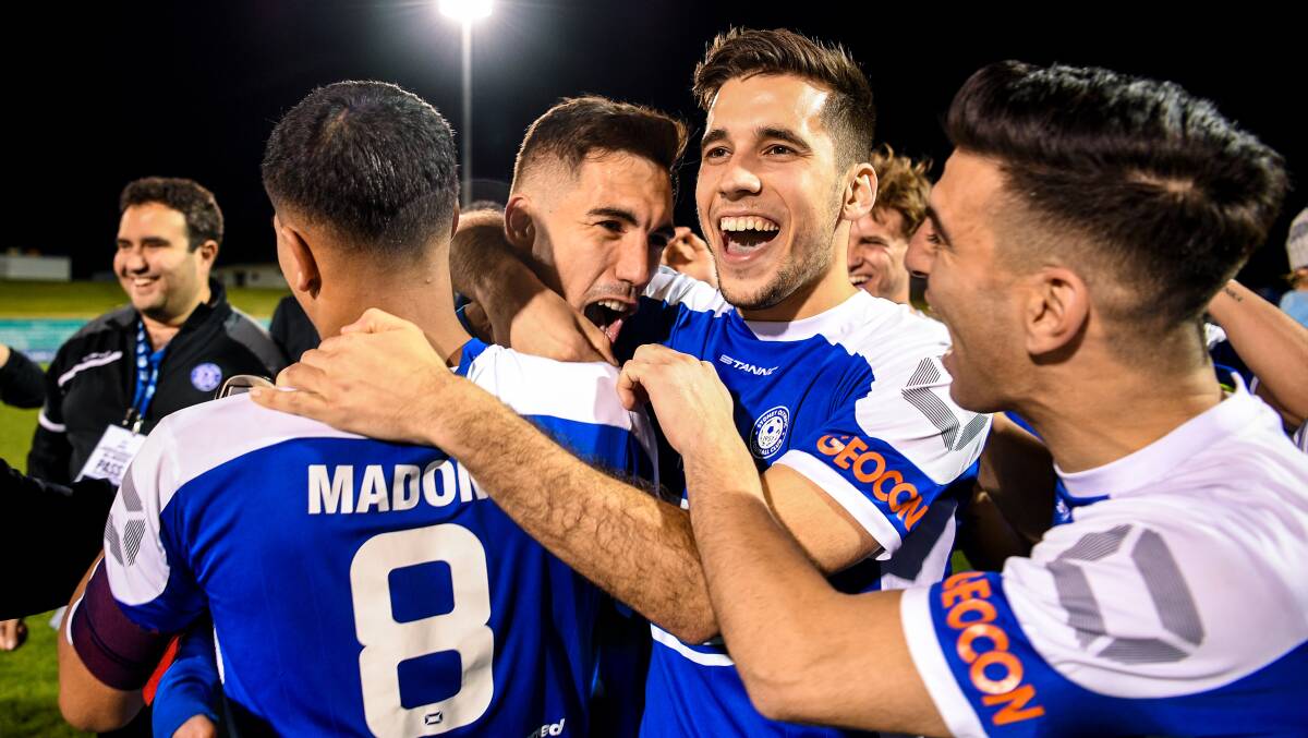 WINNERS: Olympic's Alejandro Sanchez Lopez (centre) celebrates with teammates after their victory against Apia Leichhardt Tigers. Picture: AAP Image/Brendan Esposito