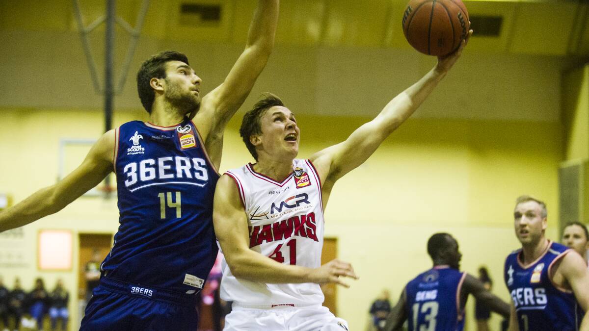 ON THE ROAD: Hawks guard Emmett Naar tries to get on the scoreboard against Adelaide 36ers in the pre-season. Photo: Dion Georgopoulos