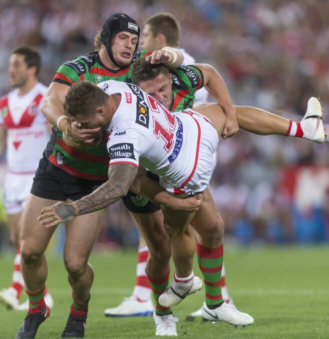 HEARTBREAKER: Tariq Sims wrestles with the Rabbitohs defence. Picture: AAP