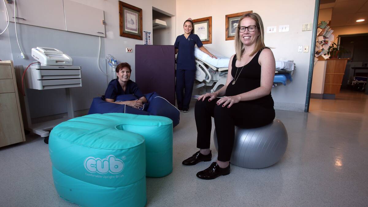 Props to them: Wollongong Hospital midwives Christina Spence and Caitlin Blunden guide Katharine Young in the use of the maternity ward's new birthing equipment on Wednesday. Picture: Robert Peet