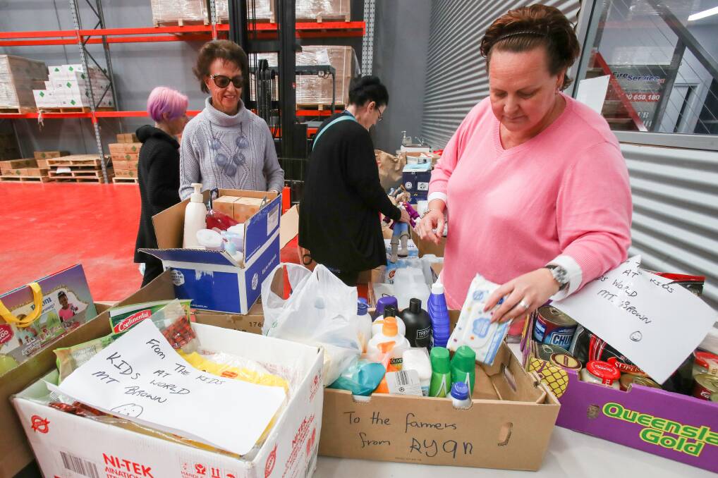 HELPING HAND: Volunteers Gina Harrison, Ros Davis Shirley Barrette and Lydia Jones packing goods that have been donated for farming families. Picture: Adam McLean