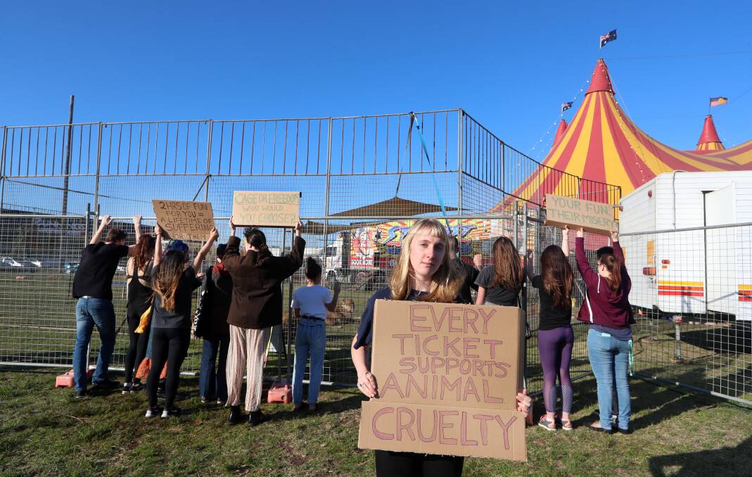 SPEAKING UP: Emily Duncan and members of the animal rights group Anonymous for the Voiceless Illawarra at the Stardust Circus lion cage at Kully Bay. Picture: Sylvia Liber.