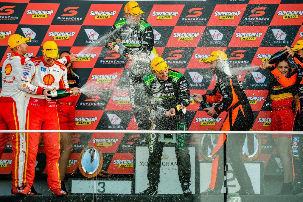 Craig Lowndes (right front) and Steven Richards (centre back) celebrate winning the Bathurst 1000 V8 Super Cars Championship at Mount Panorama, October 7, 2018.  Picture: AAP