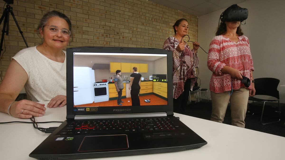 High-tech training: House With No Steps staff Angela Meyer, Cheryl Azzopardi and Rebecca Curry with the new virtual reality training tool which is being trialled in the Illawarra. Picture: Robert Peet