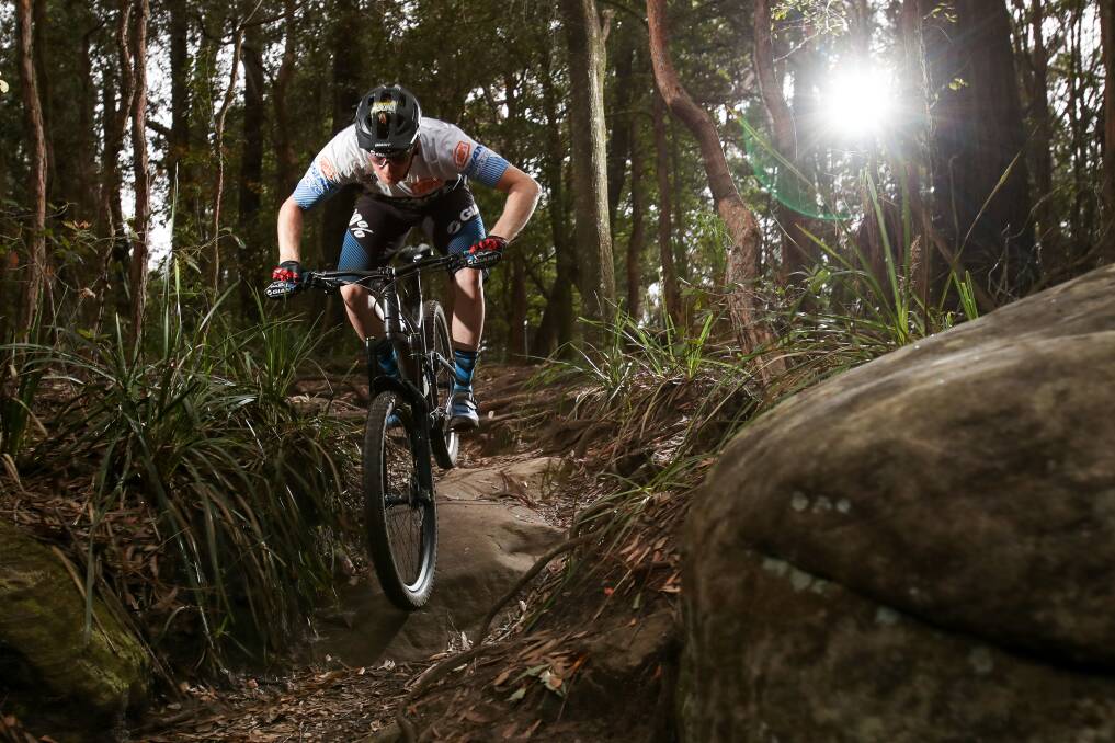 WHEELS TURN SLOWLY: Local mountain bike rider Josh Carlson riding one of the trails on Mt Keira. Picture: ADAM McLEAN.