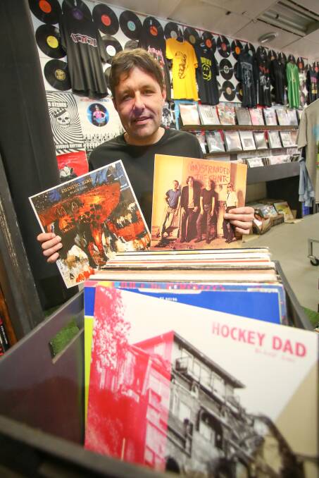 Music Farmers co-owner Jeb Taylor holding records from Wollongong band Shining Bird and The Saints that are on the YouTube Music 'Sounds of Wollongong' playlist. Picture: Adam McLean