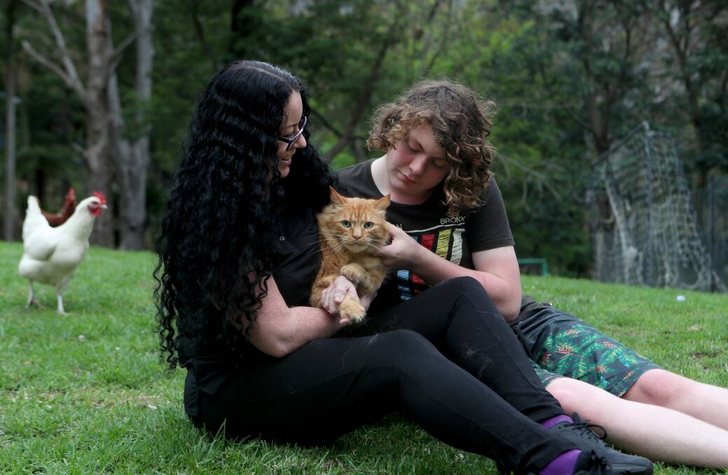 NINE LIVES: Vashti O'Rourke, her son Brock Hardy, 14, and their cat Orangey wgi nearly died after being bitten by a tick. Picture: Sylvia Liber