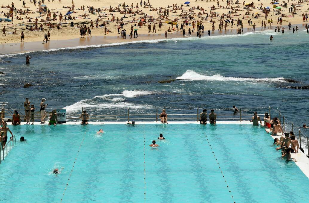 LOOK FAMILIAR: Beachgoers are seen escaping the heat at Bondi Beach last November - a similar image to that of Port Kembla's main beach. Picture: AAP