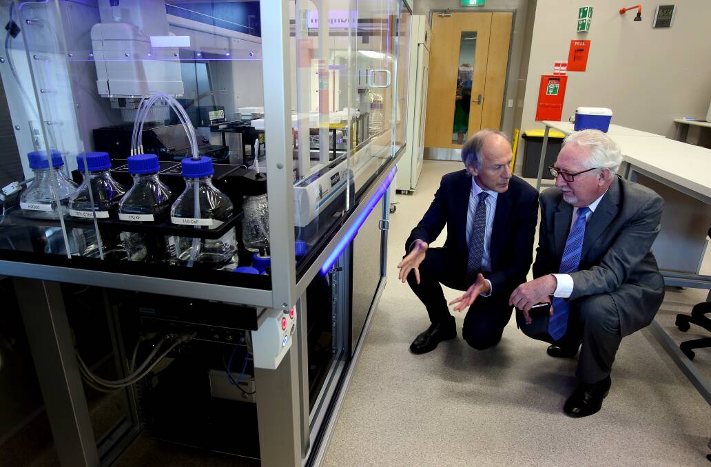 Official launch: Australia's Chief Scientist Dr Alan Finkel and IHMRI executive director Professor David Adams take a close look at the state-of-the-art machine at the new electrophysiology facility. Picture: Robert Peet