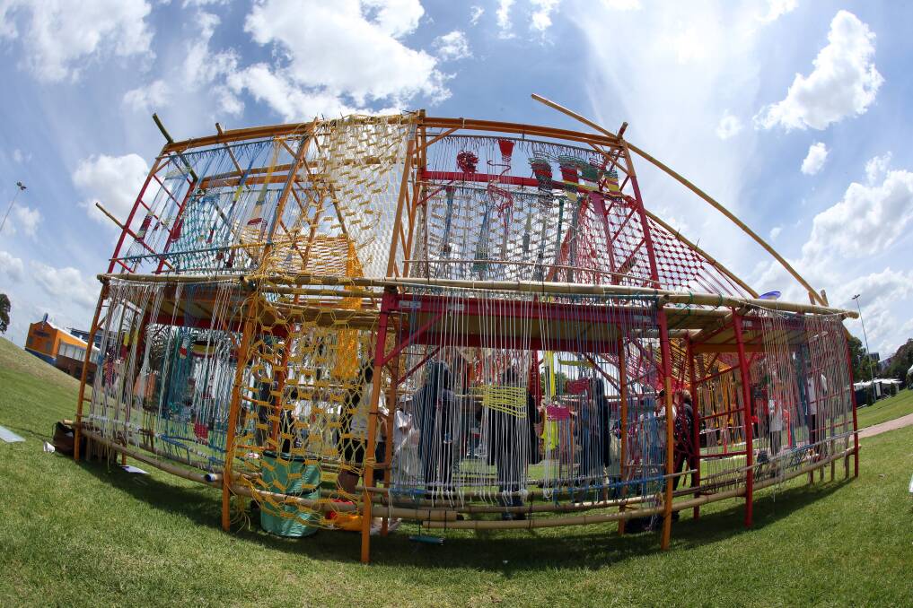 STRUNG OUT: Chaco Kato from Slow Art Collective who have created a giant loom for the public to help weave recycled materials to form an artwork.  Picture: Robert Peet