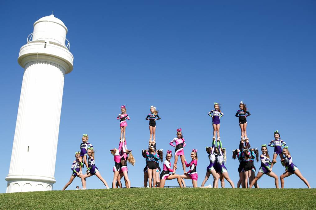 Cheerleading teams from NRG, Air Born and AOC demonstrate some of their athletic stunts. Picture: Adam McLean