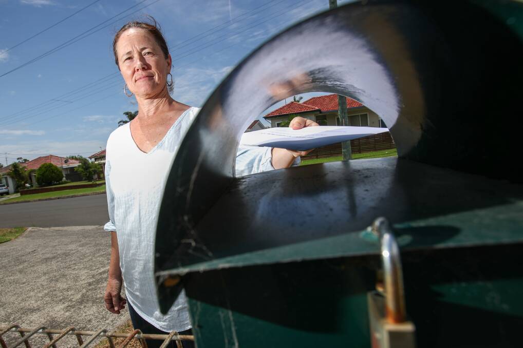 Letterbox drop: Illawarra Women's Health Centre's Sally Stevenson urges Warilla and Lake Illawarra residents to complete a survey on domestic violence in order to improve community safety. Picture: Adam McLean
