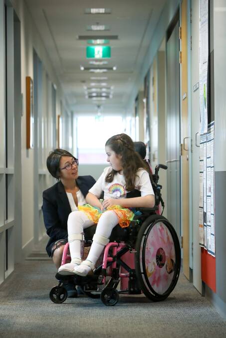 Working together: Chloe with researcher Associate Professor Lezanne Ooi who's leading the research into the cruel disease. Pictures: Adam McLean
