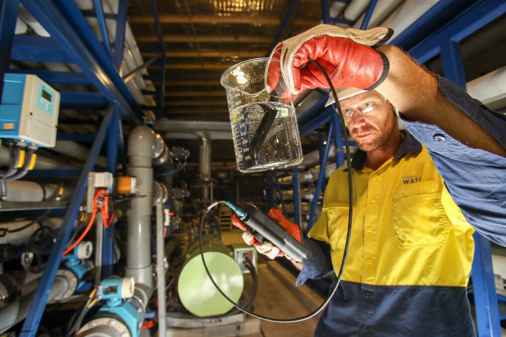 CRYSTAL CLEAR: Wollongong Water Recycling Plant process controller Hugo Figgis inspects the quality of the water from the reverse osmosis filters. Pictures: Adam McLean
