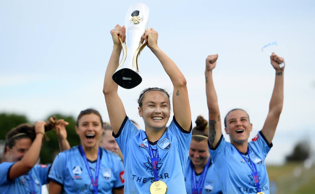 Caitlin Foord olds the W-League trophy in February. Picture: AAP Image/Dan Himbrechts