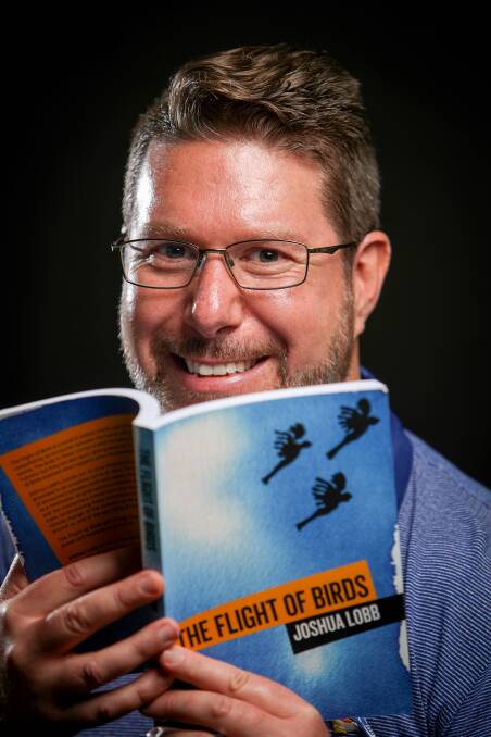Senior lecturer in creative writing at UOW, Joshua Lobb, with his first novel The Flight of Birds. Picture: Adam McLean