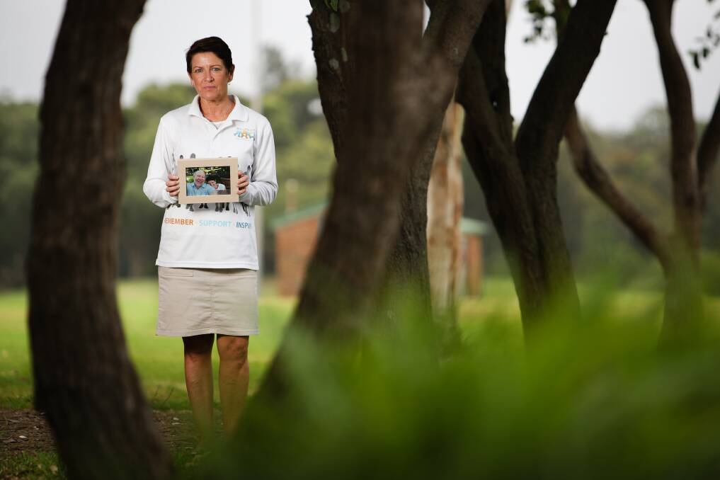 Loving memory: Anne Clarke with a photograph of her brother, Father Paul Cooney, who died of melanoma in August last year. She'll join Wollongong's Melanoma March on Sunday in his memory. Picture: Adam McLean