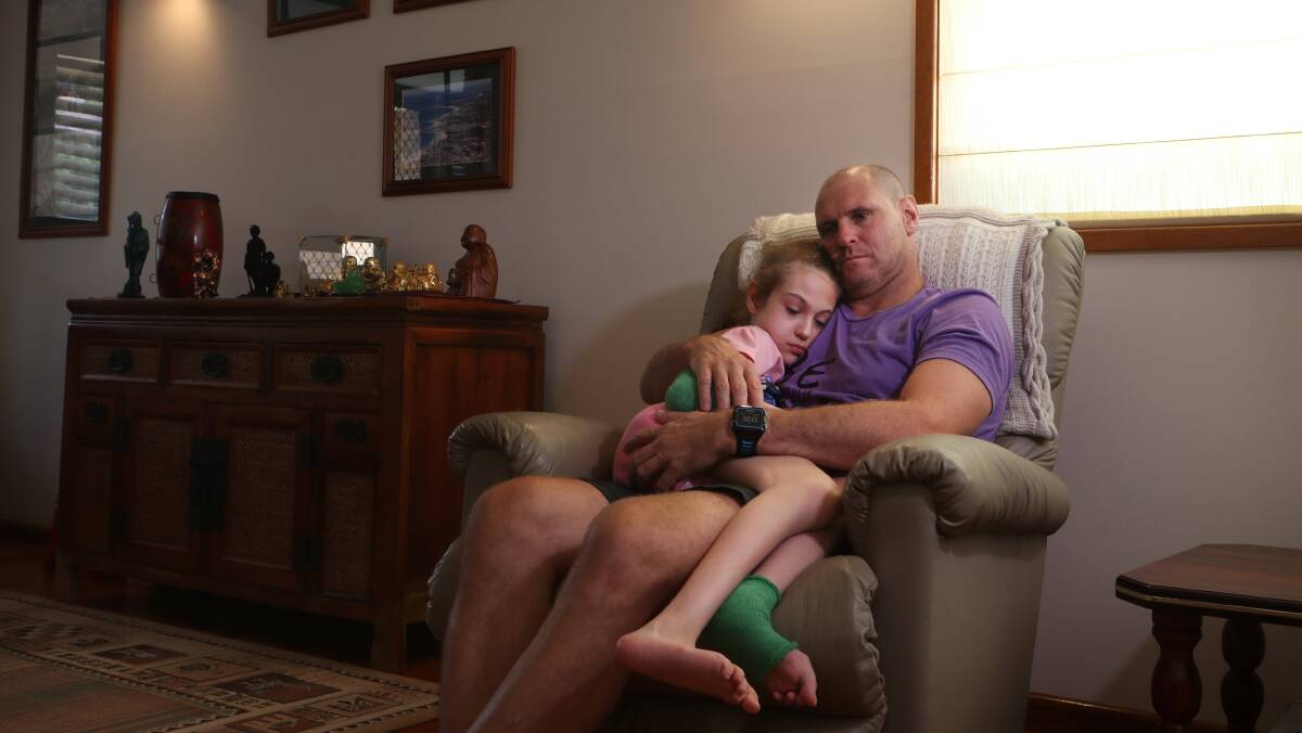 Thirroul's Mark Wilkinson with his daughter Amelia who is one of 200 Australians diagnosed with Rett syndrome. Picture: Sylvia Liber