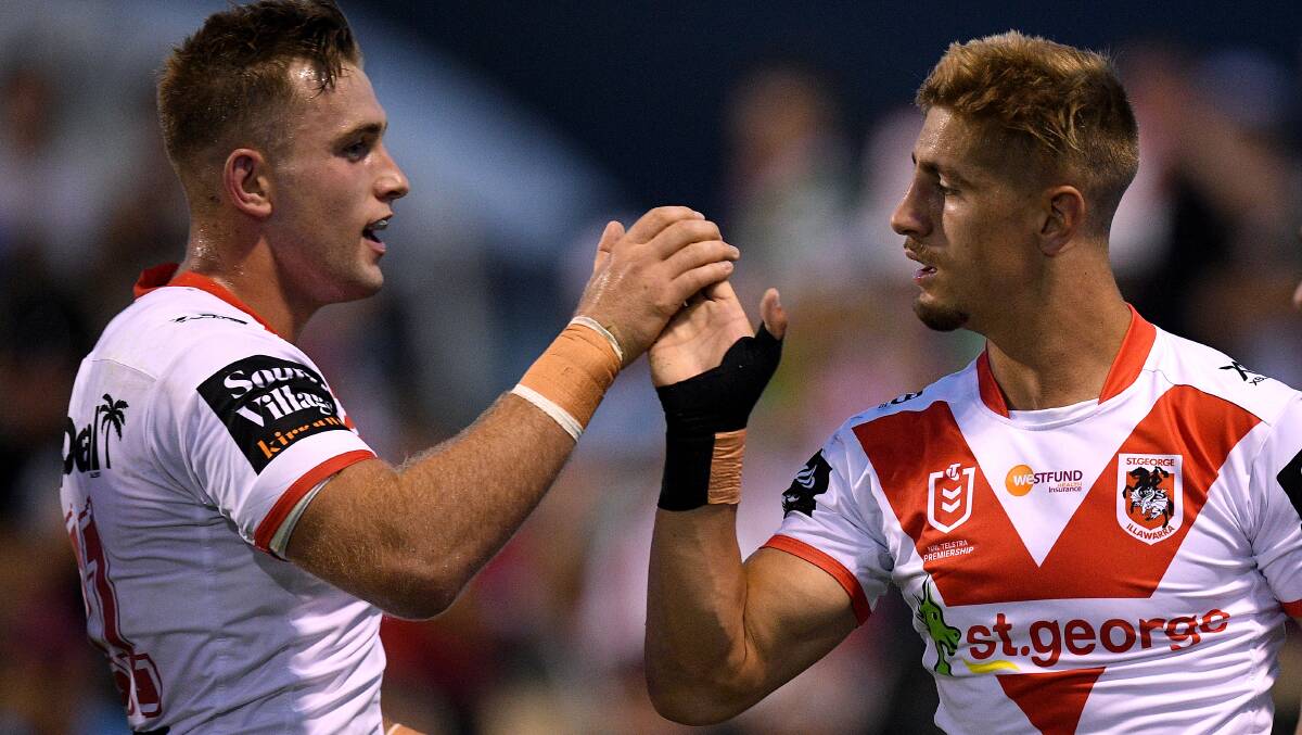 Challenge ahead: Zac Lomax of the Dragons (right) celebrates with Jacob Host after scoring a try during the Charity Shield. Picture: AAP Image/Dan Himbrechts