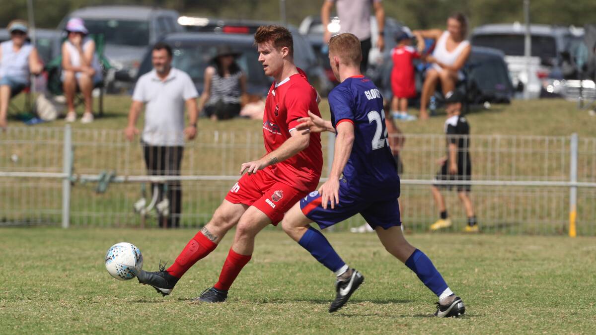 SOLID START: Wolves defender Nick Littler passes it during Wollongong's win over Manly United at Albert Butler Memorial Park. Picture: Robert Peet