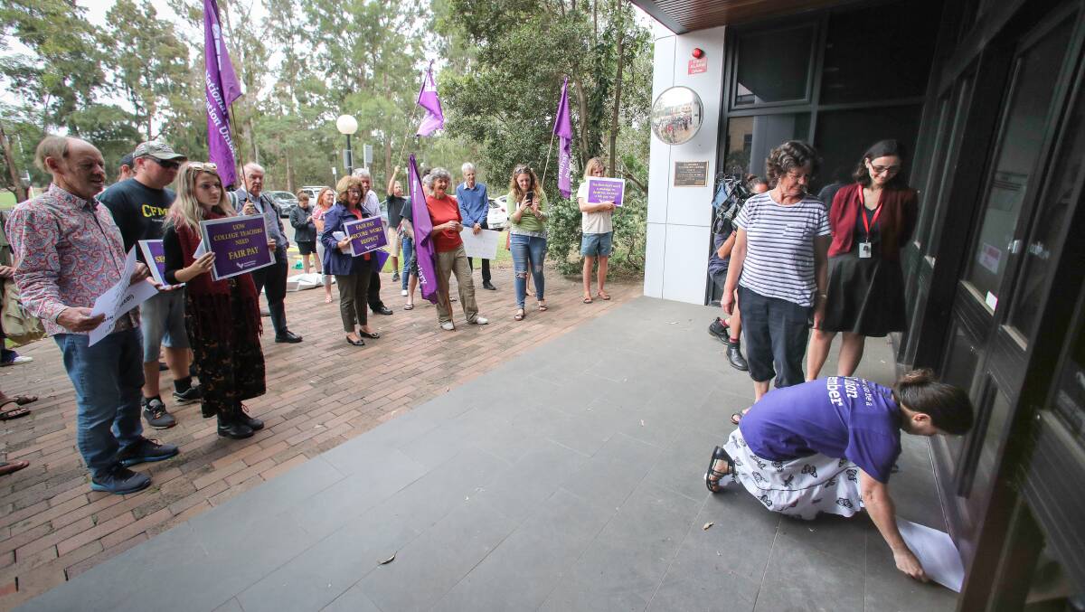 DENIED ENTRY: UOW College teacher Jann Roberts was forced to shove the resolution letter through the door. Picture: Adam McLean