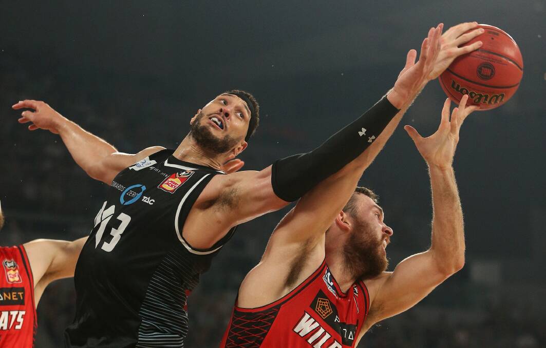Rising up: Melbourne's Josh Boone takes on ex-Hawks' big man Nick Kay during the NBL finals series. Picture: AAP Image/Hamish Blair