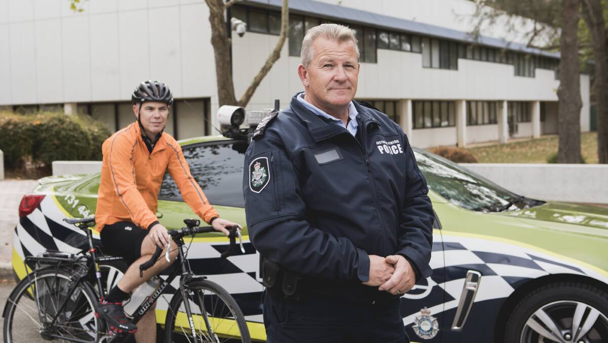 Head of ACT Policing road safety operations team Marcus Boorman with cyclist and fellow officer James Sutherland.


Photo: Jamila Toderas